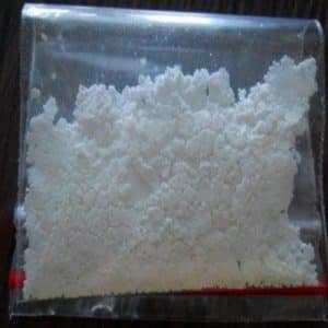 A clear plastic bag containing a fine, white powder, labeled as MDMA powder.