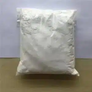 A sealed plastic bag containing white powder, placed on a flat surface.